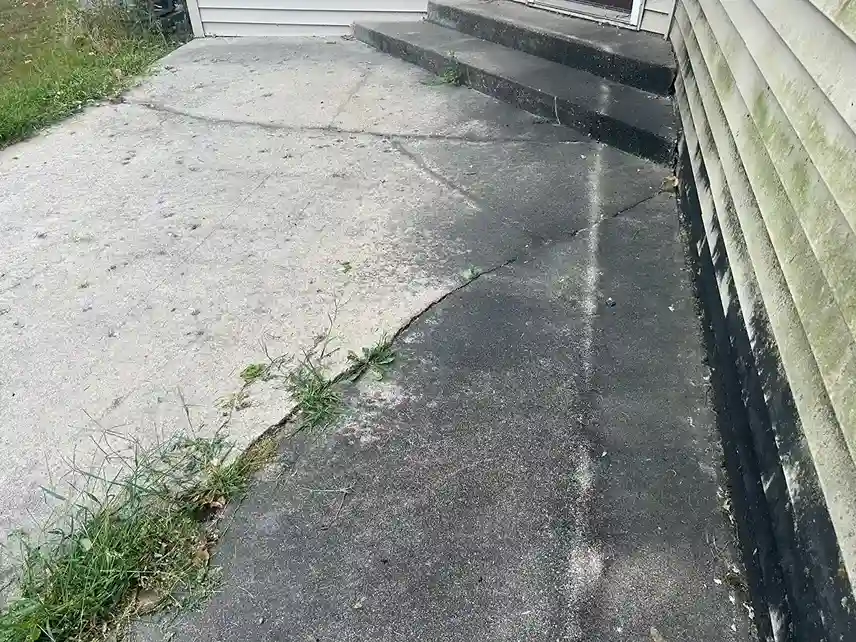 Concrete driveway pressure washing removing tire marks and grime in Morris MN
