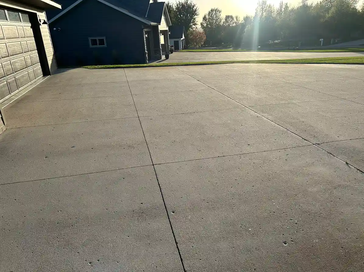 Streak-free rotary surface cleaner at work on residential concrete slab